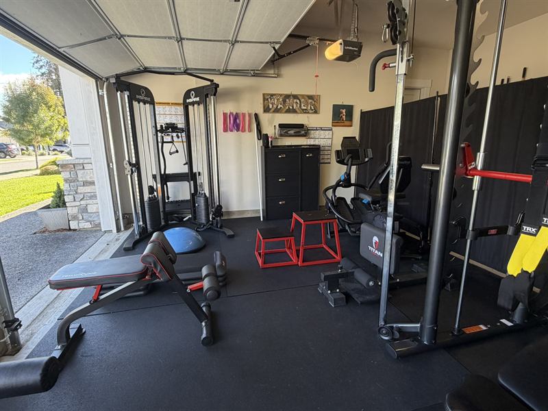 The POWHER training floor with power rack, benches, plyo boxes and rubber flooring